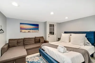 a living room with two beds and a couch at Outstanding Home Relaxing Rooftop with Patio & Grill in Philadelphia