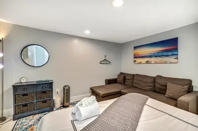 a living room with a bed and a couch at Outstanding Home Relaxing Rooftop with Patio & Grill in Philadelphia