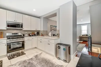 a large kitchen with white cabinets and appliances at Outstanding Home Relaxing Rooftop with Patio & Grill in Philadelphia