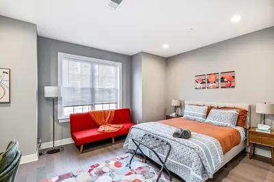 a bedroom with a red bed and a red chair at Exceptional Downtown Townhome with Roof Deck -4Bedroom & 3Baths in Philadelphia