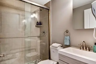 a bathroom with a shower and a toilet and a sink at Exceptional Downtown Townhome with Roof Deck -4Bedroom & 3Baths in Philadelphia