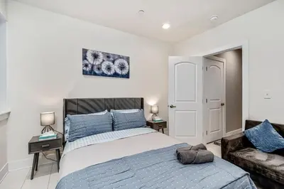 a bedroom with a bed and a couch at Exceptional Downtown Townhome with Roof Deck -4Bedroom & 3Baths in Philadelphia