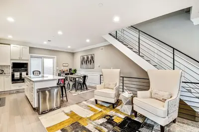 a kitchen and living room with a staircase at Exceptional Downtown Townhome with Roof Deck -4Bedroom & 3Baths in Philadelphia