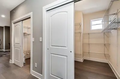 a walk in closet with a white door at Exceptional Downtown Townhome with Roof Deck -4Bedroom & 3Baths in Philadelphia