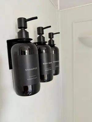 three bottles of shampoo are hanging on a wall at Professional & Student-Friendly in Upper Darby