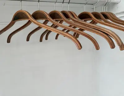 a group of wooden hangers in a closet at Professional & Student-Friendly in Upper Darby