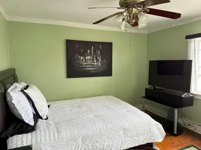 a bedroom with a bed and a flat screen tv at Professional & Student-Friendly in Upper Darby