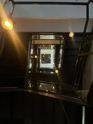 a room with a window and lights on the ceiling at Sosuite at The Queen - Queen Village in Philadelphia