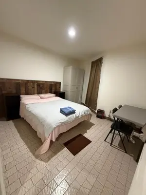 a bedroom with a bed and a desk in it at Hudson Yard 4 in New York