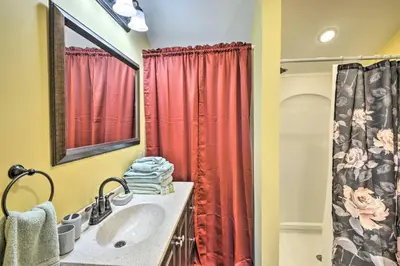 a bathroom with a sink and a red shower curtain at Woodland Hideout near Ski Adventures in Pleasant Mount