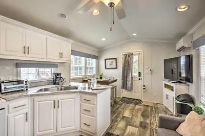 a kitchen with white cabinets and a sink at Woodland Hideout near Ski Adventures in Pleasant Mount