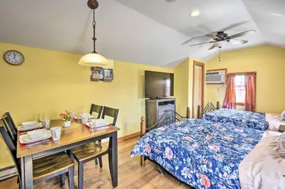 a bedroom with a bed and a desk with a table at Suite to Unwind Close to Skiing in Pleasant Mount