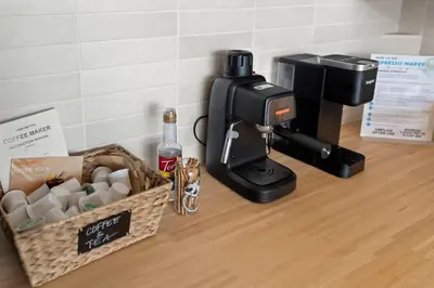 a coffee machine sitting on a counter next to a box of cups at Bright 2-Bed Loft in Northern Liberties Walk to Dining, Museums in Philadelphia