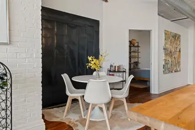 a dining room with a white table and white chairs at Bright 2-Bed Loft in Northern Liberties Walk to Dining, Museums in Philadelphia