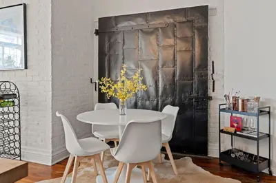 a dining room with a white table and white chairs at Bright 2-Bed Loft in Northern Liberties Walk to Dining, Museums in Philadelphia