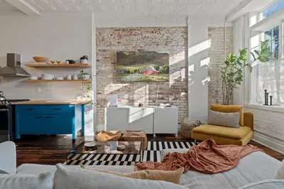 a living room with a brick wall at Bright 2-Bed Loft in Northern Liberties Walk to Dining, Museums in Philadelphia