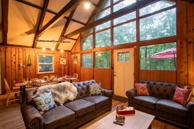 a living room with two couches and a table at Gorgeous Chalet in the Poconos w/ Hot Tub! in Locust Lakes Village