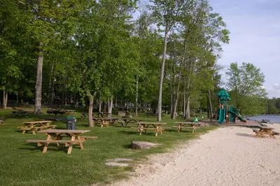 a park with wooden picnic tables and a playground at Gorgeous Chalet in the Poconos w/ Hot Tub! in Locust Lakes Village