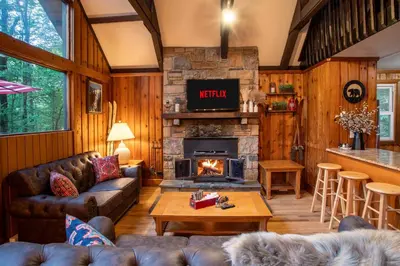 a living room with a couch and a fireplace at Gorgeous Chalet in the Poconos w/ Hot Tub! in Locust Lakes Village