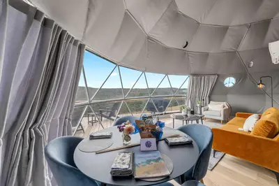 a room with a table and chairs and a large window at Catskills Glamping at 'The Deer Dome' in Franklin in Franklin