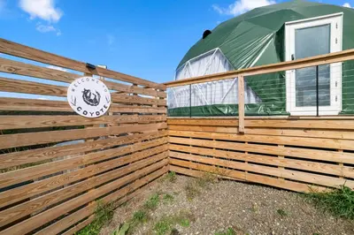 a house with a fence and a green dome at Glamping Getaway at 'The Coyote Dome' in Franklin in Franklin
