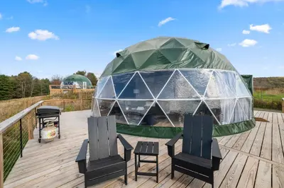 a gazebo on a deck with two chairs at Glamping Getaway at 'The Coyote Dome' in Franklin in Franklin