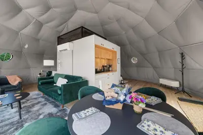 a living room with a table and chairs in a yurt at Glamping Getaway at 'The Coyote Dome' in Franklin in Franklin