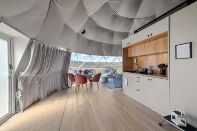 a kitchen with a tent with chairs and a table at 'The Bear Dome' with Barrel Hot Tub in Franklin in Franklin