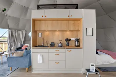 a kitchen in a tent with a bed in it at 'The Bear Dome' with Barrel Hot Tub in Franklin in Franklin