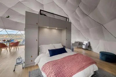 a bedroom with a large bed in a tent at 'The Bear Dome' with Barrel Hot Tub in Franklin in Franklin