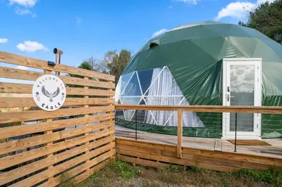 a dome house with a wooden fence at Barrel Hot Tub at 'The Eagle Dome' in Franklin in Franklin