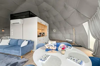 a room with a couch and a table in a tent at Barrel Hot Tub at 'The Eagle Dome' in Franklin in Franklin