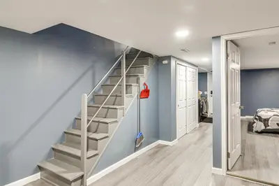 a staircase in a room with a blue wall at Pet Friendly! NW Philly Rowhouse with Fenced Yard! in Philadelphia