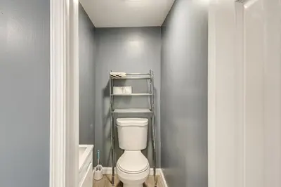 a bathroom with a white toilet in a room at Pet Friendly! NW Philly Rowhouse with Fenced Yard! in Philadelphia
