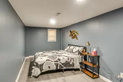 a bedroom with a bed and a blue wall at Pet Friendly! NW Philly Rowhouse with Fenced Yard! in Philadelphia