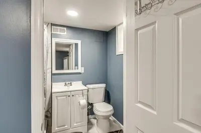 a bathroom with a white toilet and a sink at Pet Friendly! NW Philly Rowhouse with Fenced Yard! in Philadelphia