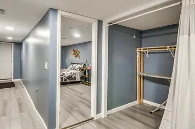 a room with blue walls and a bedroom with a bed at Pet Friendly! NW Philly Rowhouse with Fenced Yard! in Philadelphia