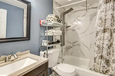 a bathroom with a toilet and a sink and a shower at Pet Friendly! NW Philly Rowhouse with Fenced Yard! in Philadelphia