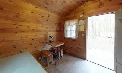 a log cabin with a desk and a window at Jellystone Park PA Wilds in Mansfield