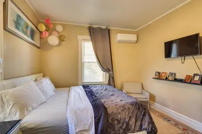 a bedroom with a bed and a flat screen tv at Easy Commute to Newark and NYC! Extended Stay Unit in Irvington