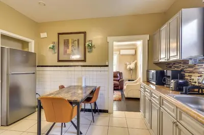 a kitchen with a table and a stainless steel refrigerator at Easy Commute to Newark and NYC! Extended Stay Unit in Irvington