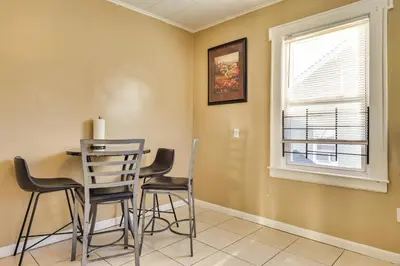 a dining room with two chairs and a table and a window at Free Parking Spot! Extended Stay Near Newark and NYC in Irvington