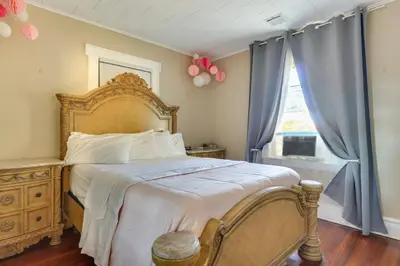 a bedroom with a large bed with blue curtains at Free Parking Spot! Extended Stay Near Newark and NYC in Irvington