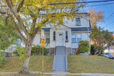 a white house with stairs leading to the front door at Free Parking Spot! Extended Stay Near Newark and NYC in Irvington