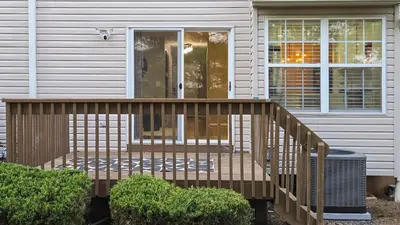 a wooden deck in front of a house at Spacious 3BR Near Rutgers plus Princeton plus NYC Access in Franklin Park