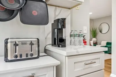 a kitchen with a counter with a coffee maker on it at Spacious 3BR Near Rutgers plus Princeton plus NYC Access in Franklin Park