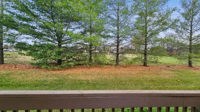 a park with trees and a field with a fence at Spacious 3BR Near Rutgers plus Princeton plus NYC Access in Franklin Park