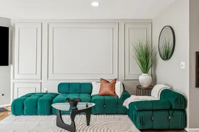 a living room with a green couch and a table at Spacious 3BR Near Rutgers plus Princeton plus NYC Access in Franklin Park