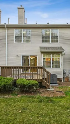 a house with a wooden deck in front of it at Spacious 3BR Near Rutgers plus Princeton plus NYC Access in Franklin Park