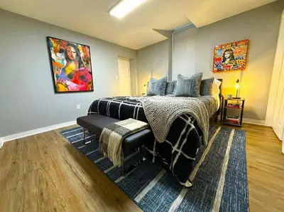 a bedroom with a bed and a painting on the wall at Crossroads at Park Place in Wilmington